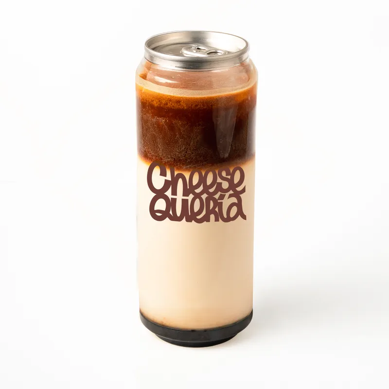 Vainilla Madagascar: café sobre leche y una capa oscura en el fondo, en lata transparente con el logo de Cheesequería